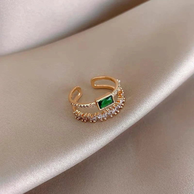 Lustrous Gold Ring with Emerald and Zirconia Details